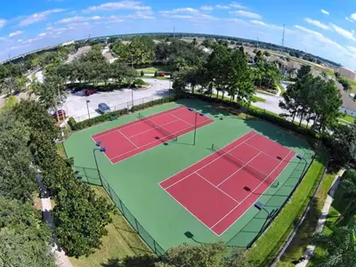 an overhead view of two tennis courts with trees at Condo Disney Universal Epic Pool in Kissimmee
