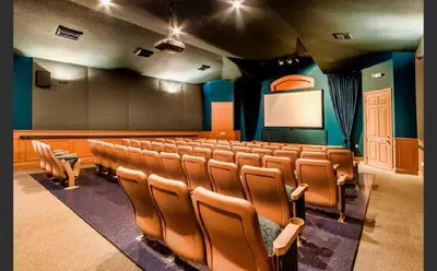 an auditorium with chairs and a screen in a theater at Condo Disney Universal Epic Pool in Kissimmee