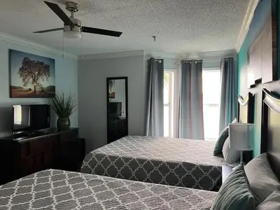 a bedroom with two beds and a window at Condo Near Disney-Universal-Epic-Sea World in Orlando