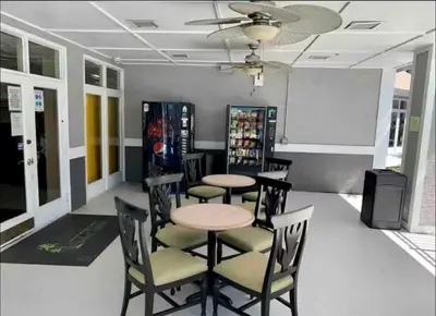 a dining room with tables and chairs and a whiteboard at Condo Near Disney-Universal-Epic-Sea World in Orlando