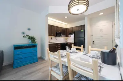 a kitchen and dining room with a table and chairs at Inspiration condo near Disney with free shuttle in Orlando