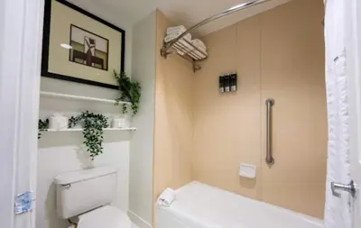 a bathroom with a toilet and a shower at Inspiration condo near Disney with free shuttle in Orlando