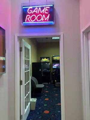 a game room with a neon sign on the wall at Inspiration condo near Disney with free shuttle in Orlando