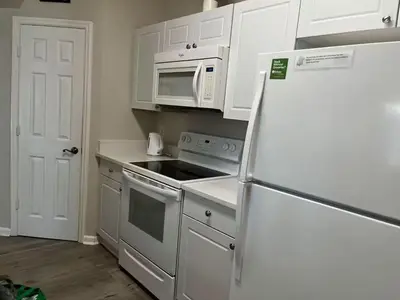 a kitchen with a refrigerator and a microwave at Apartment Disney Universal Epic in Orlando
