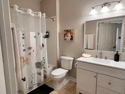 a bathroom with a toilet and a sink and a mirror at Apartment Disney Universal Epic in Orlando