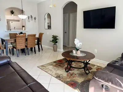 a living room with a couch and a table at Apartment Disney Universal Epic in Orlando