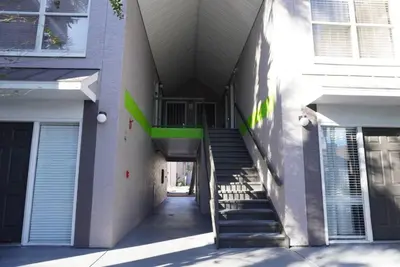 a hallway of a building with stairs and a balcony at Condo near Disney Universal Free Parking in Orlando