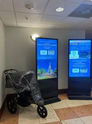 a baby stroller sitting next to two posters in a room at Renovated Condo near Disney Free Shuttle to Parks in Orlando