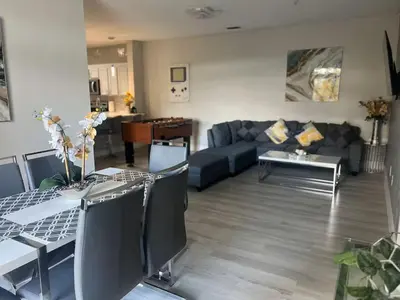 a living room with a couch and a table at Amazing Condo near Disney in Kissimmee