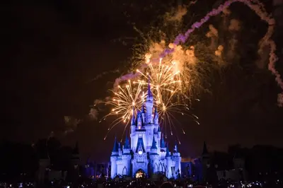 a disney castle with fireworks at night at Renovated 4 bed3 bath Townhome near Disney in Kissimmee