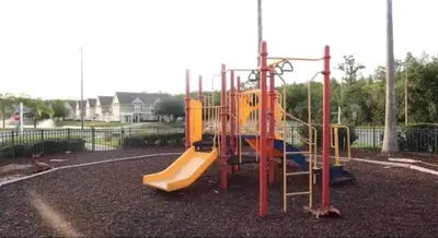 a playground with a slide in a park at Renovated 4 bed3 bath Townhome near Disney in Kissimmee