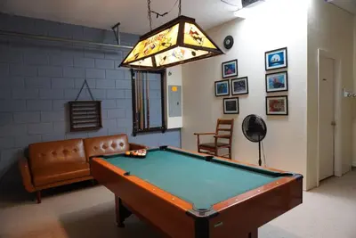 a room with a pool table and a chandelier at Villa near Disney Jacuzzi Pool 4bed-3baths in Kissimmee