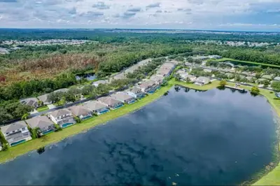 an aerial view of a home next to a body of water at Villa near Disney Jacuzzi Pool 4bed-3baths in Kissimmee