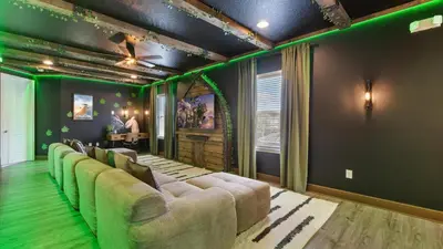 a living room with a couch and green walls at Upstay Spacious 5BR Villa Private Pool and Hot Tub in Orlando