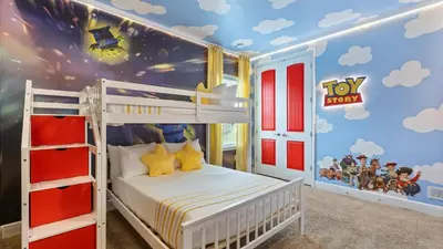 a bedroom with a bunk bed with a toy story mural at Upstay Spacious 5BR Villa Private Pool and Hot Tub in Orlando
