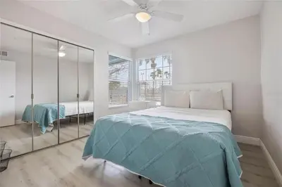 a white bedroom with a bed and a ceiling fan at 3BR Condo Near Disney, with Clubhouse, Pool and Gym in Kissimmee