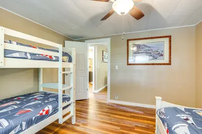 a bedroom with two bunk beds and a ceiling fan at Lakefront Home with Hot Tub and Dock in Orlando! in Orlando