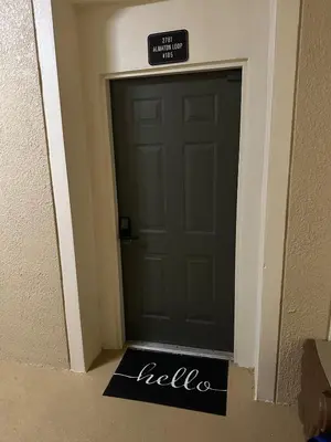a door in a hallway with a sign on it at PalmTree Oasis 3 bedroom Condo at Windsor Hills in Orlando