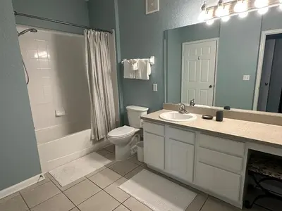 a bathroom with a toilet and a sink and a shower at PalmTree Oasis 3 bedroom Condo at Windsor Hills in Orlando