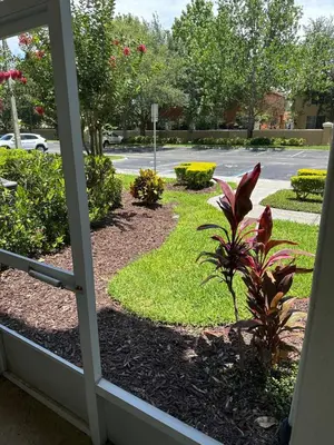 a view of a garden from a window at PalmTree Oasis 3 bedroom Condo at Windsor Hills in Orlando
