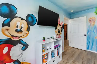 a room with a mickey mouse mural on the wall at Magical 3BR Luxury Condo - 15 Mins to Disney in Kissimmee