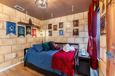 a bedroom with a bed and a wall with pictures at Magical 3BR Luxury Condo - 15 Mins to Disney in Kissimmee