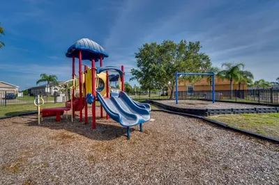 a playground with a slide in a park at Kissimmee Resort-Style Home Close to Shops and Eats in Kissimmee