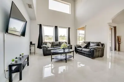 a living room with two couches and a table at Kissimmee Resort-Style Home Close to Shops and Eats in Kissimmee