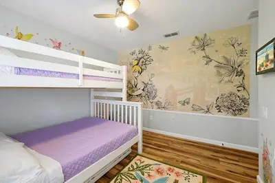 a childs bedroom with a bunk bed and a mural at 6 Bedroom Villa located in Windsor Hills 3 miles to Disney Free Heated Pool & Spa Game Room with PS5! in Orlando