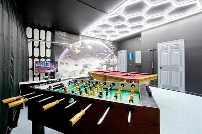 a ping pong table in a room with a pool table at 6 Bedroom Villa located in Windsor Hills 3 miles to Disney Free Heated Pool & Spa Game Room with PS5! in Orlando