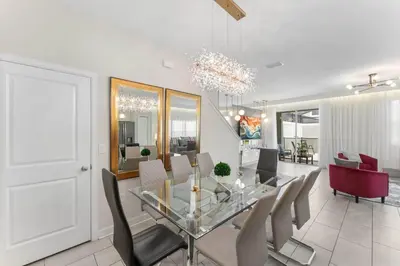 a dining room with a glass table and chairs at 4822 Resort Pool House Disney Universal Orlando in Kissimmee