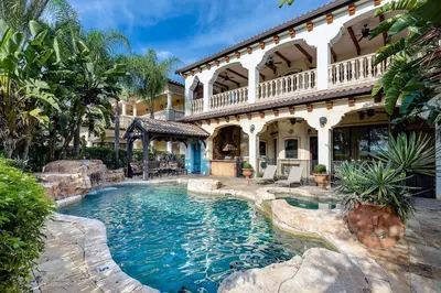 a swimming pool in front of a house at 24-7 Vacation Club! Affordable Vacation Stays, Multiple Units Available, All Over Florida! Name your price today! in Kissimmee
