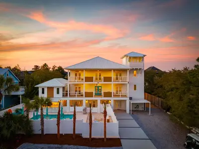 a house with a pool in front of a sunset at 24-7 Vacation Club! Affordable Vacation Stays, Multiple Units Available, All Over Florida! Name your price today! in Kissimmee
