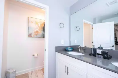 a bathroom with two sinks and a mirror at Last Minute Disney Private Pool Themed Bedrooms. Book Now SLR516 in Kissimmee