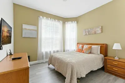 a bedroom with a bed and a desk and a window at Last Minute Disney Luxury Condo with Balcony. Book Now WP77 in Orlando