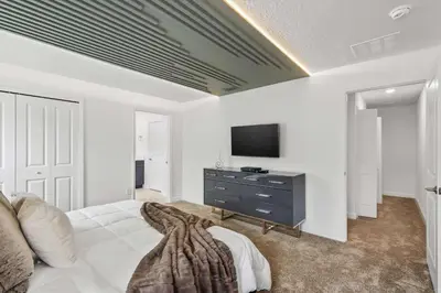 a bedroom with a bed and a tv on a wall at Storey Lake Resort 510 - Hosted by Top Villas in Kissimmee