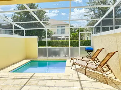 a patio with two chairs and a swimming pool at TR1435RC - 3BR - Sleeps 8 in Orlando