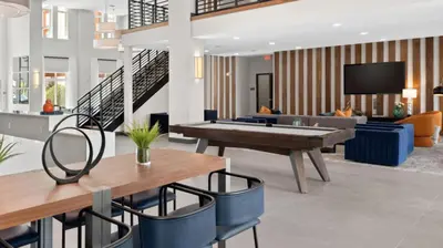 a living room with a ping pong table and chairs at Landing Incredible 1BD Gym Clubhouse in Orlando
