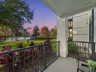 a balcony with a view of a park at Magnificent 2 Bedroom Apt Vista Cay Resort 107 in Orlando