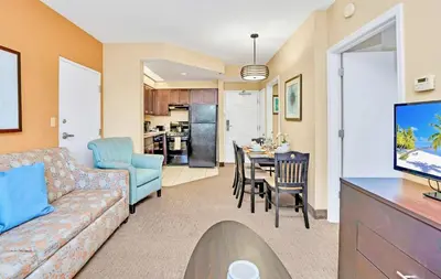 a living room with a couch and a dining room at King Suite near to Disney & Universal Fun in Orlando