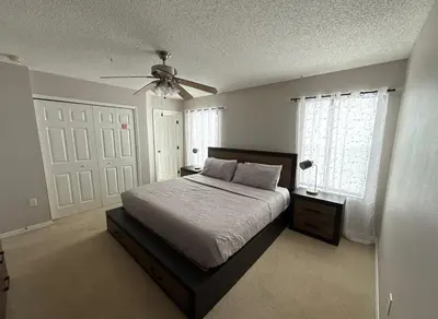 a bedroom with a bed and a ceiling fan at Family & Group Haven-Resort Style Living-Near Disney in Kissimmee