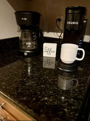 a counter top with a coffee maker and a coffee mug at Family & Group Haven-Resort Style Living-Near Disney in Kissimmee