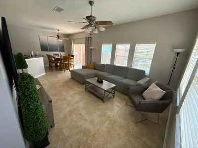 a living room with a couch and a table at Family & Group Haven-Resort Style Living-Near Disney in Kissimmee