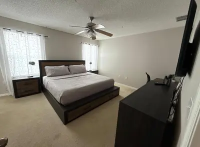 a bedroom with a bed and a ceiling fan at Family & Group Haven-Resort Style Living-Near Disney in Kissimmee