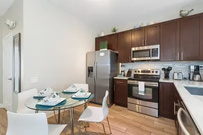 a kitchen with a table and chairs and a refrigerator at Amazing 3BDR House with pool in Kissimmee