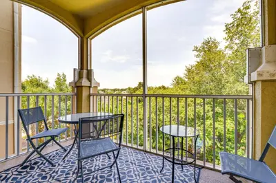 a balcony with two tables and chairs and a view at 4 Mi to Disney Family-Friendly Resort Getaway! in Orlando