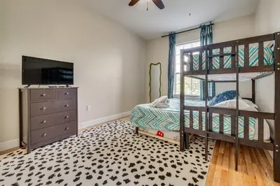 a bedroom with a bunk bed with a dresser and a television at 4 Mi to Disney Family-Friendly Resort Getaway! in Orlando