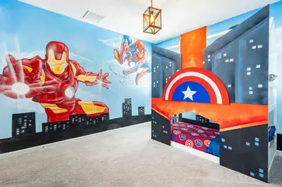 a bedroom with a superhero mural on the wall at Sleeps 36 | 15 Bedroom! Theater! Resort! POOL! in Kissimmee