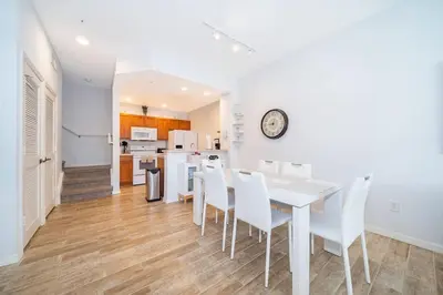 a kitchen and dining room with a table and chairs at Charming 3BrTownhome near Disney in Kissimmee
