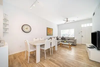 a white living room with a table and a couch at Charming 3BrTownhome near Disney in Kissimmee